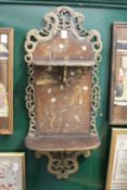 A Japanese painted and inlaid wall shelf (AF).