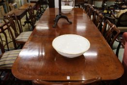 A good George III design mahogany twin pedestal dining table with two extra leaves.