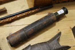 A leather covered telescope.