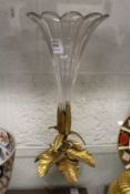 A cut glass trumpet shaped vase with ormolu base.
