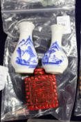 A small pair of Chinese blue and white vases and a cinnabar snuff bottle.