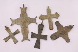 A group of bronze crosses.