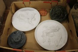 A pair of pottery circular plaques and three other decorative plaques.