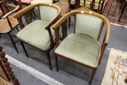 A pair of mahogany shaped horseshoe shaped armchairs.