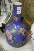 A Chinese blue ground mallet shaped bottle vase painted with flowering trees.