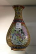 A Chinese Famille Jaune bottle shaped vase decorated with female figures.