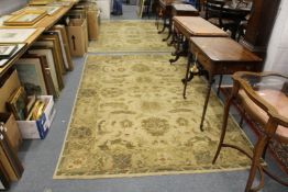 A pair of Indian rugs, beige ground with stylized floral decoration.