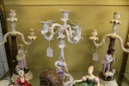 A pair of continental porcelain figural candelabra and another similar.
