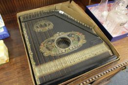 A piano harp with original cardboard box.