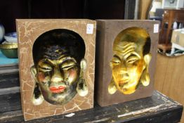 A pair of unusual moulded Chinese plaques with faces.