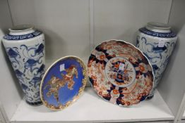 A large Imari dish, a Satsuma dish and a pair of modern Chinese blue and white vases.