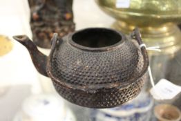 A Chinese cast iron teapot.