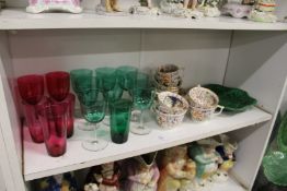 A collection of cranberry and green glassware, Derby cups and saucers and a cabbage leaf dish.