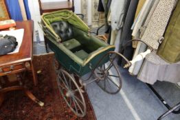 An unusual rare early leather and wrought iron pram.