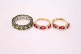 A pair of earrings and a silver ring.