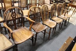 Six 19th century ash and elm wheel back dining chairs, two with arms.