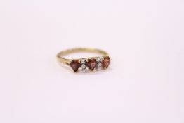 A 9ct gold ring set with three heart shaped stones.