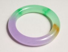 A MULTI COLOURED JADE BANGLE.