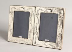 A PAIR OF SILVER ART NOUVEAU STYLE PHOTOGRAPH FRAMES. 8ins x 5.5ins.