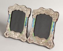 A PAIR OF SILVER AND ENAMEL ART NOUVEAU STYLE PHOTOGRAPH FRAMES 8.5ins x 5.5ins