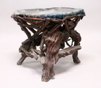 AN UNUSUAL FLOUROSPAR AND ROOTWOOD STAND OF NATURALISTIC DESIGN. 2ft wide x 1ft 8ins high.