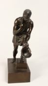 A GRAND TOUR BRONZE OF A MAN CARRYING A HELMET on a rectangular base 9ins high