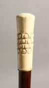 A 19TH CENTURY WALKING CANE with engraved ivory handle 37ins long