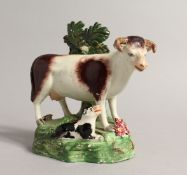 A PAIR OF STAFFORDSHIRE BOCAGE GROUPS OF A COW AND CALF 5.5ins high.