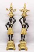 A SUPERB LARGE PAIR OF 19TH CENTURY STANDING NUBILE FIGURE CANDELABRAS formed as a a pair of African
