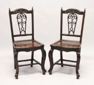 A GOOD PAIR OF 19TH CENTURY REDWOOD CHINESE CHAIRS with pierced backs and solid seats on curving