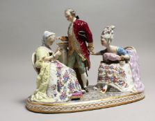 A LARGE 19TH CENTURY GERMAN PORCELAIN GROUP, a gallant and two ladies sitting in arm chairs. 9ins