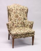 A GEORGIAN STYLE MAHOGANY WING ARM CHAIR with loose cushions on tapering legs.