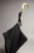 A LADIES PARASOL, with a mother of pearl and gilt metal handle. 31ins long