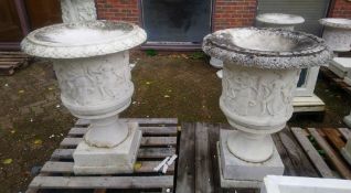 A GOOD PAIR OF ITALIAN CARVED WHITE MARBLE URNS , the sides carved with dancing muses 2ft 6ins high