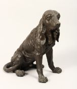 A NATURALISTICALLY MODELLED AND CAST BRONZE FIGURE OF A SEATED DOG. 1ft 2ins high.