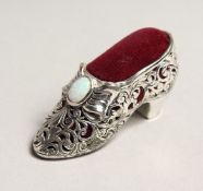 A NOVELTY SILVER SHOE PIN CUSHION.