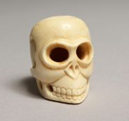 A CARVED BONE SKULL