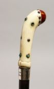 AN EDWARDIAN IVORY HANDLE WALKING CANE with silver band and cabochon stones, F. WEST CARNE, 59