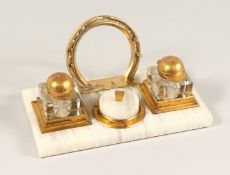 A 1930'S ONYX AND GILT METAL HORSE RACING INKSTAND with horse shoe and caps.