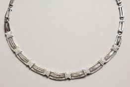 AN 18CT WHITE GOLD AND DIAMOND TRIPLE ROW NECKLACE in folding leather case.