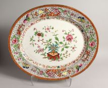 A LARGE OVAL MEAT DISH painted with flowes 20ins long