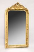 A LARGE ORNATE GILT FRAMED ARCH TOP MIRROR, the top with moulded leafwork decoration. 5ft high x 2ft