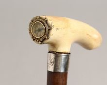 A GOOD 19TH CENTURY WALKING STICK with bone handle inset with a compass and silver band. 31ins long