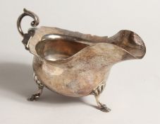 A SILVER SAUCE BOAT, with scroll handle on shell and hoof feet. Sheffield 1903 7ozs