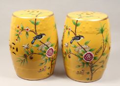 A PAIR OF CHINESE PORCELAIN BARREL SEATS, yellow ground, decorated with birds on flowering