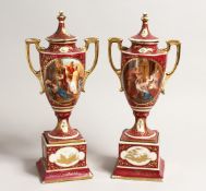 A PAIR OF 19TH CENTURY VIENNA TWO HANDLED URN SHAPE VASES AND COVERS, painted with classical scenes.