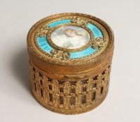 A FRENCH CIRCULAR GILDED METAL AND ENAMEL BOX with portrait of a young girl and mirror inside the