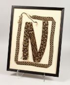 TWO CHIMU FABRIC BELTS, framed and glazed. 19.5ins x 15ins.