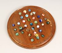 A LARGE 19TH CENTURY MAHOGANY CIRCULAR SOLITAIRE BOARD 11.5ins diameter with thirty three 1.5cm