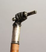 A 19TH CENTURY CANE with plated handles as a clenched fist holding a gun. Inscribed `RAYNER' 35ins